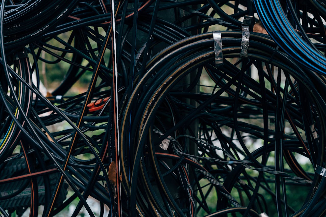 Services Close-up view of a complex tangle of electrical wires outdoors.