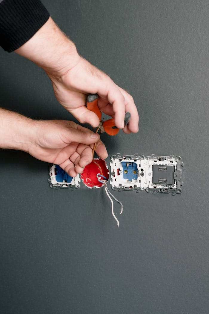 The Art of Drawing Readers In: Your attractive post title goes here Crop anonymous electrician installing sockets and switches in room with gray walls in daytime