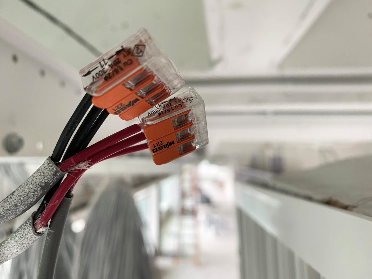 About Detailed view of splicing connectors and wires in an indoor setting, ideal for technology-related projects.
